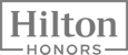 The image shows the "Hilton Honors" logo in a rectangular frame, with "Hilton" above "Honors" in bold, stylized text.