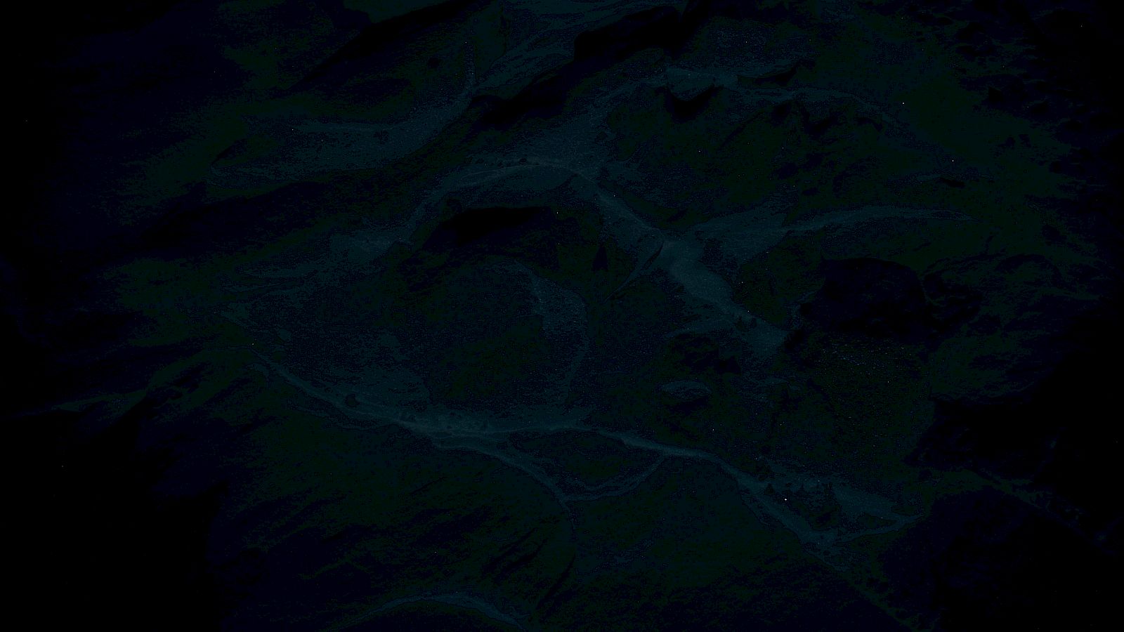 The image is very dark, making it difficult to identify specific details or objects within it.